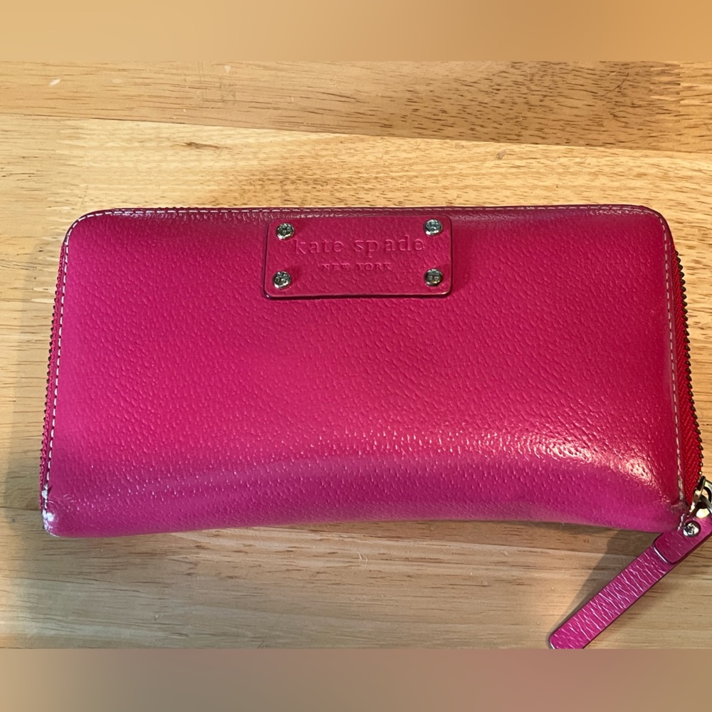 Pink zippered Kate Spade wallet. Gently used. 8”x4”.